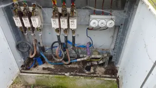 W skrzynce elektrycznej widoczne są bezpieczniki i przewody. To miejsce wymaga przeglądu, by potwierdzić oświadczenie o gotowości instalacji przyłączanej.